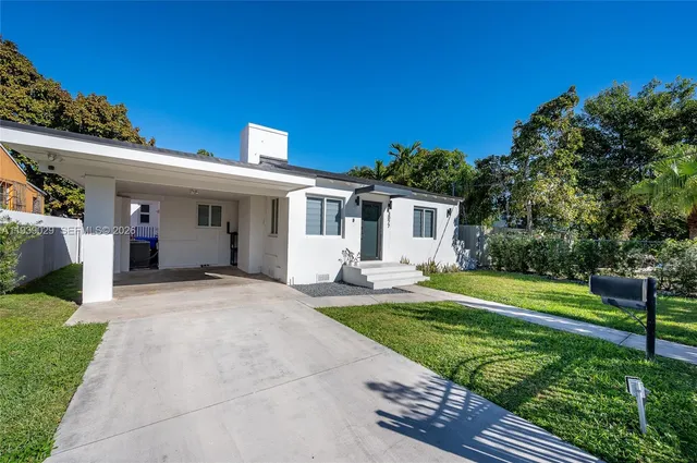 a front view of a house with a yard and porch
