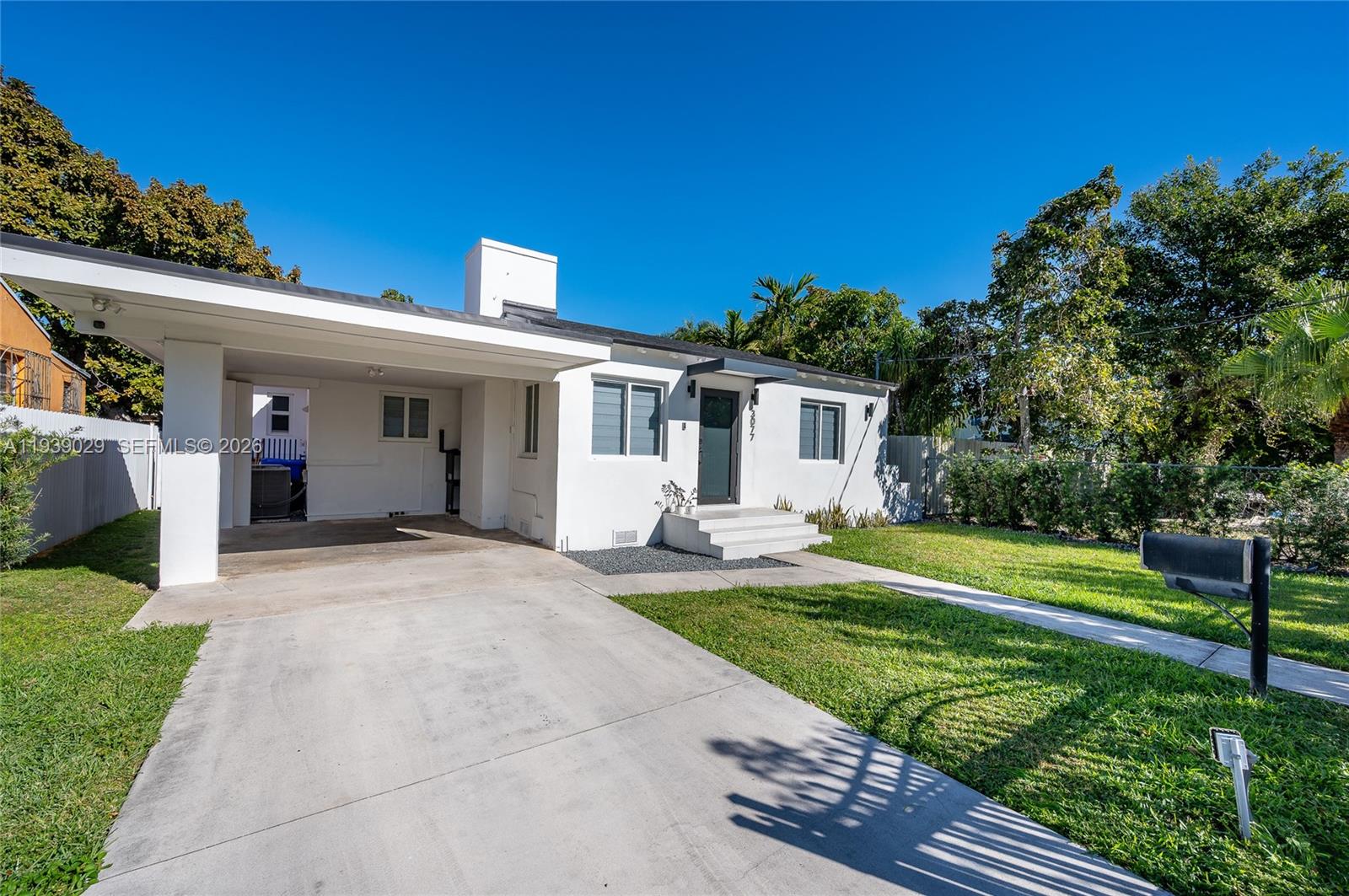 3077 Southwest 5th Street Miami, FL 33135 - Photo 2 of 25 a front view of a house with a yard and porch