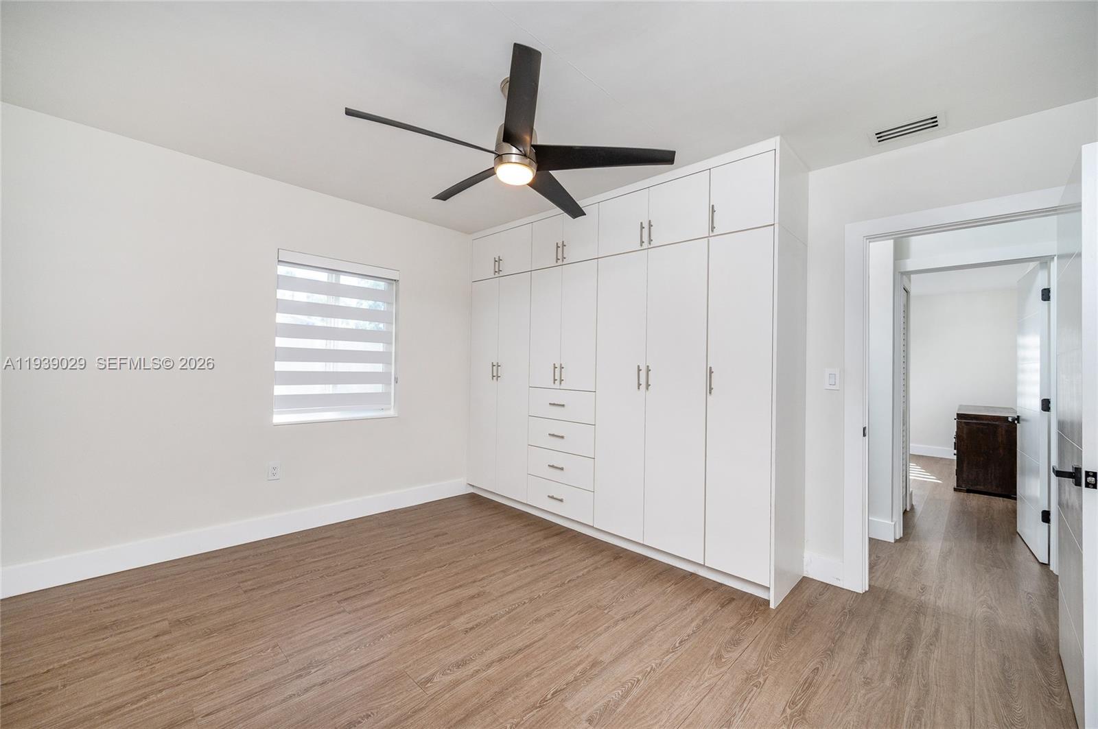 3077 Southwest 5th Street Miami, FL 33135 - Photo 22 of 25 wooden floor in an empty room with a window