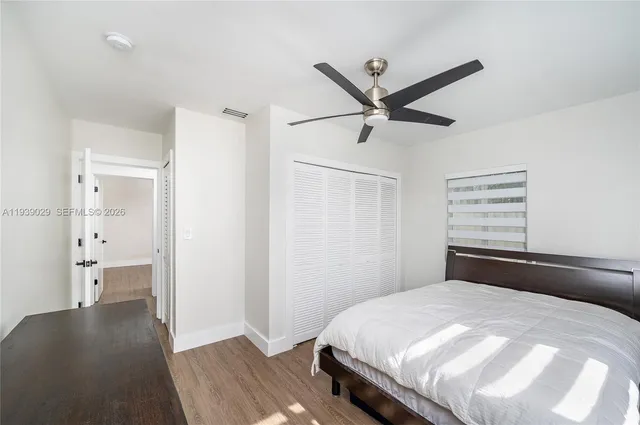 a bedroom with a bed and a ceiling fan