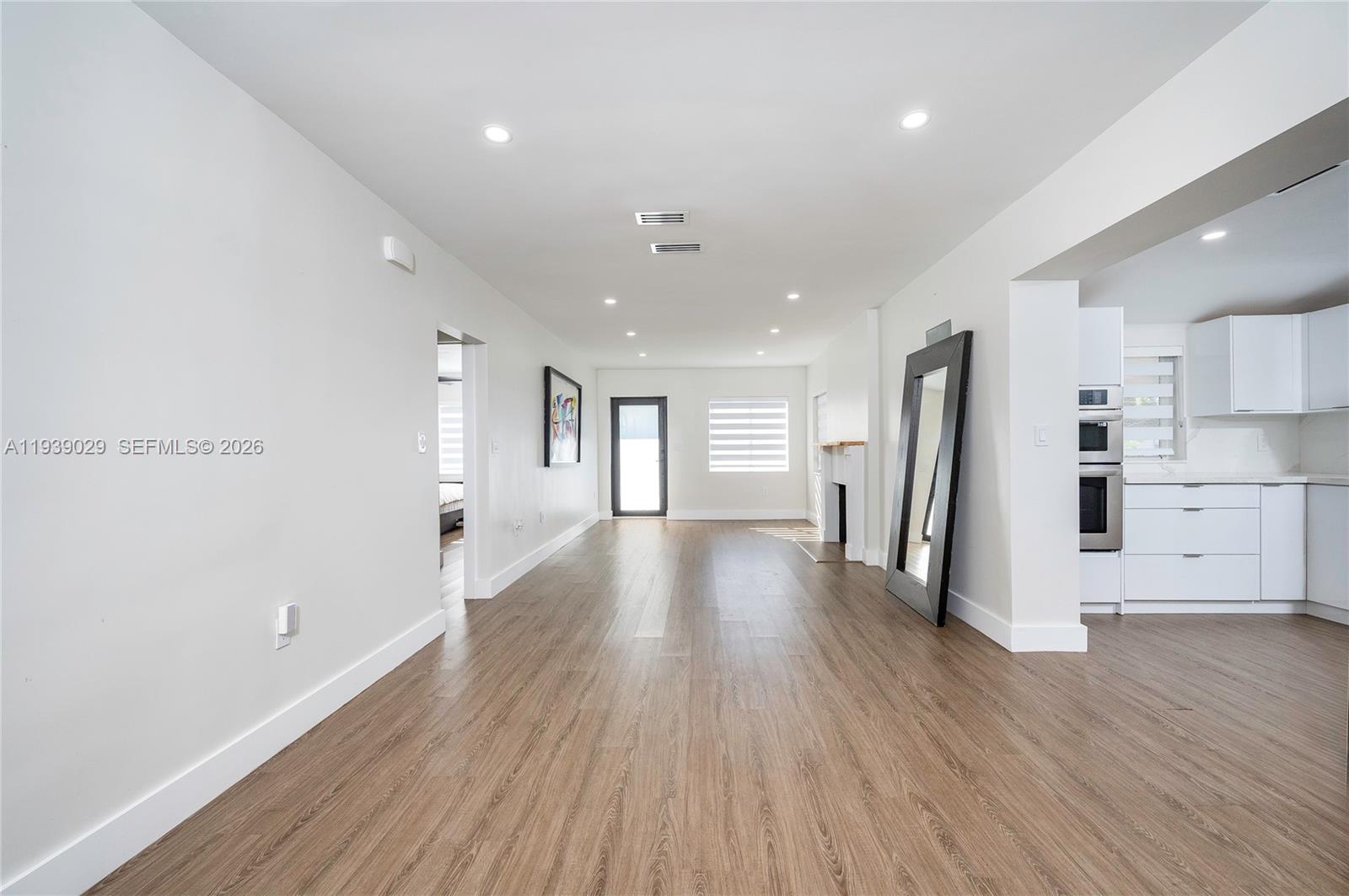 3077 Southwest 5th Street Miami, FL 33135 - Photo 8 of 25 a view of a kitchen with refrigerator and wooden floor
