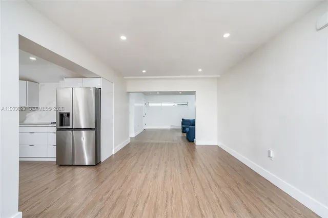 a view of a refrigerator in kitchen and wooden floor