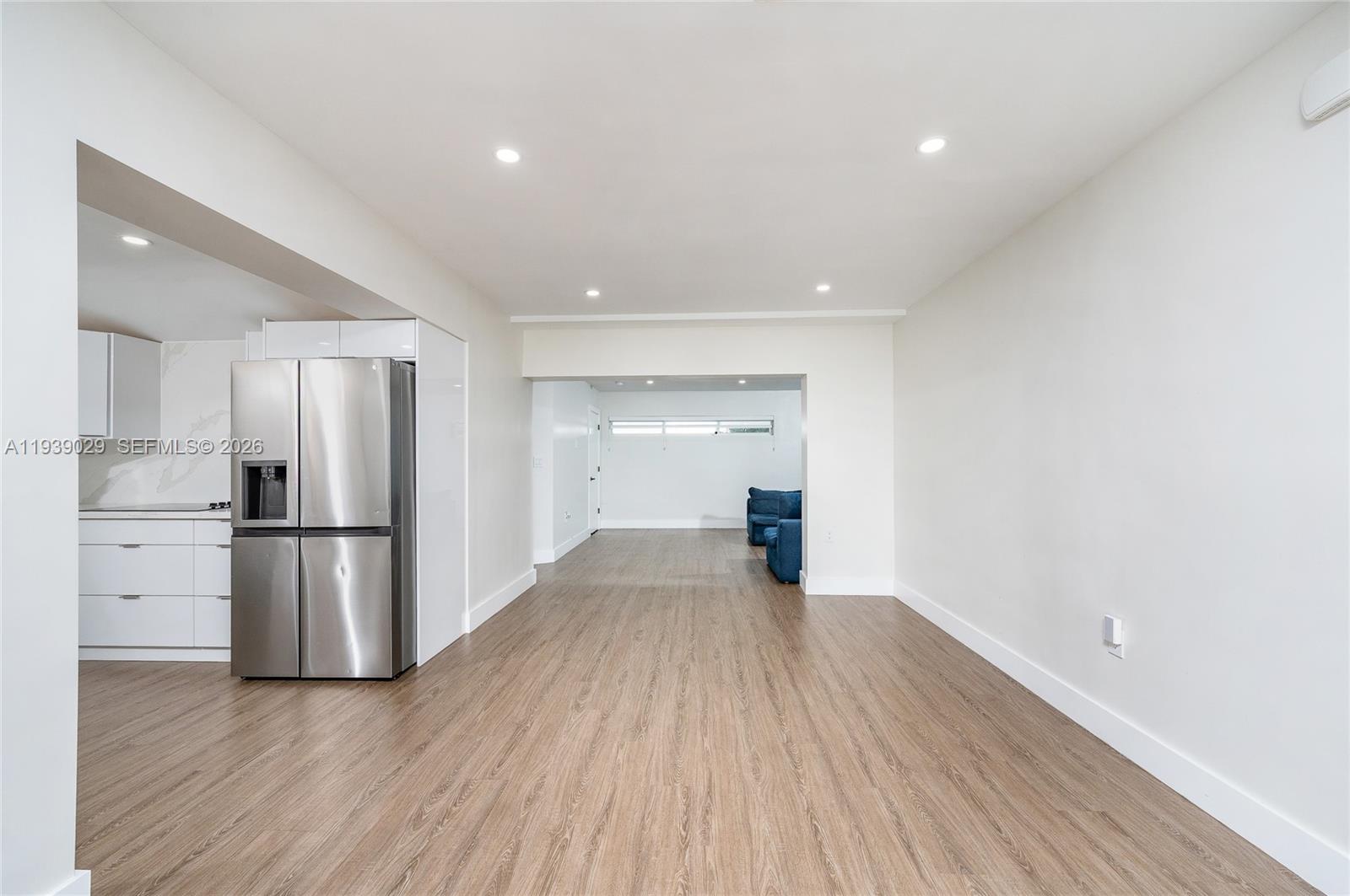 3077 Southwest 5th Street Miami, FL 33135 - Photo 10 of 25 a view of a refrigerator in kitchen and wooden floor