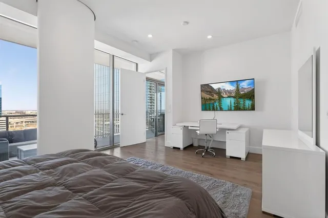 a bedroom with a bed and a flat screen tv