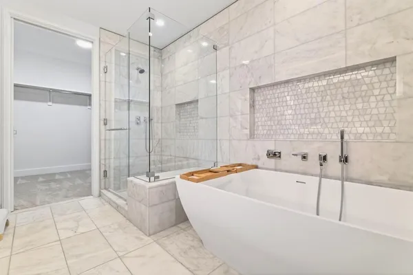 a bathroom with a bathtub and a shower