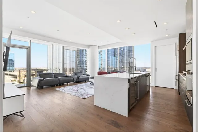 a large white kitchen with a large window