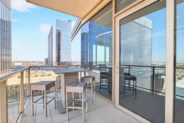 a view of a chairs and table in the balcony