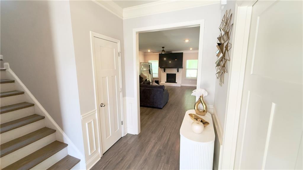 3370 Elkhorn Ridge Run Dacula, GA 30019 - Photo 3 of 29 a view of a hallway view with wooden floor and staircase