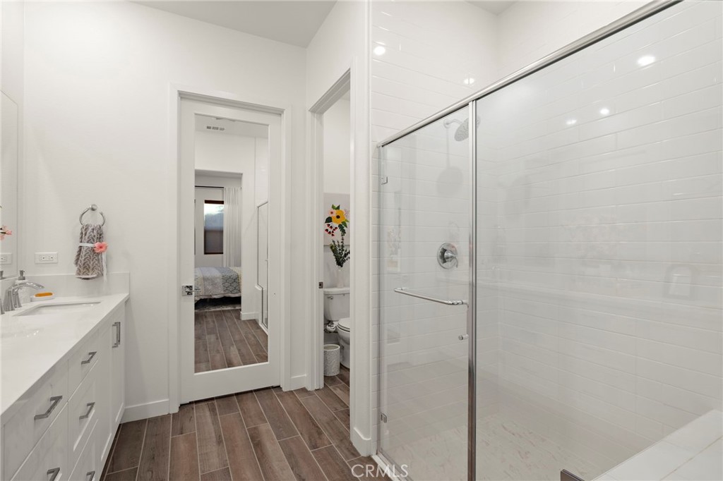 756 Sunrise Road Rancho Mission Viejo, CA 92694 - Photo 11 of 32 a bathroom with a granite countertop sink a mirror and shower