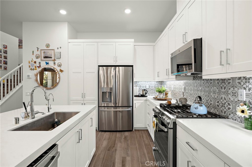 756 Sunrise Road Rancho Mission Viejo, CA 92694 - Photo 6 of 32 a kitchen with refrigerator a sink and cabinets