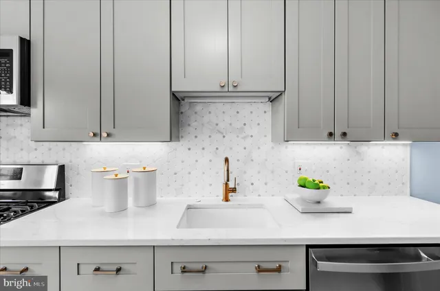 a kitchen with a sink cabinets and wooden floor