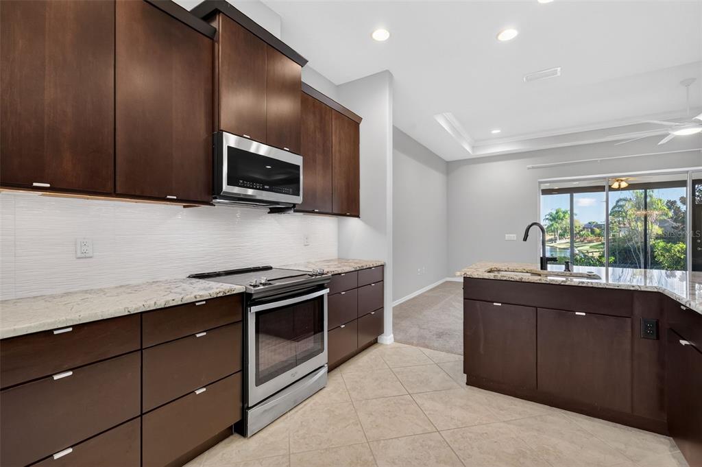 2389 Pawtucket Pass Mount Dora, FL 32757 - Photo 16 of 67 a kitchen with stainless steel appliances granite countertop a stove and a sink