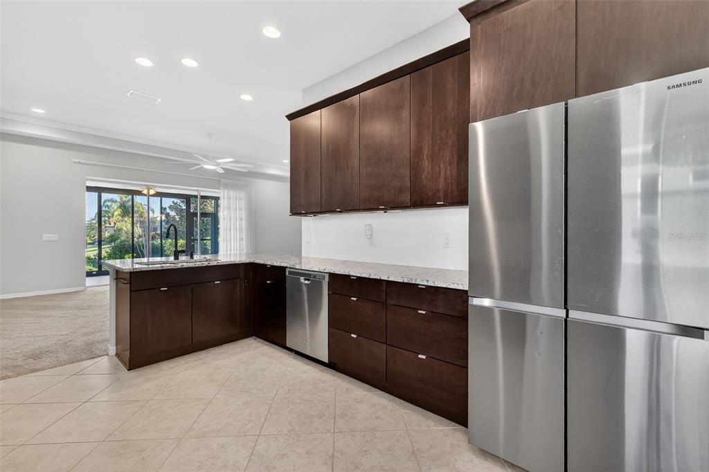 2389 Pawtucket Pass Mount Dora, FL 32757 - Photo 17 of 67 a kitchen with a refrigerator and a sink