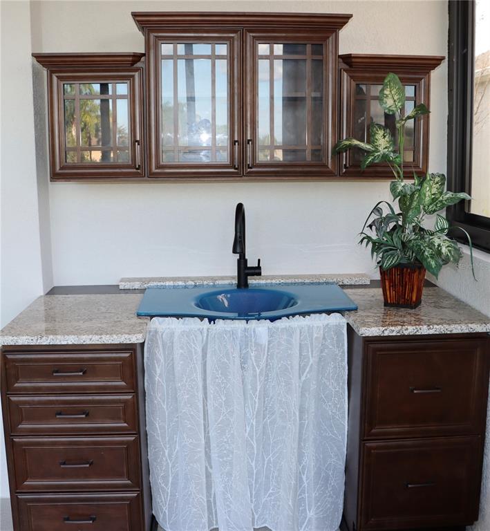 2389 Pawtucket Pass Mount Dora, FL 32757 - Photo 40 of 67 a kitchen with stainless steel appliances granite countertop a coffee maker on granite counter tops and a view of living room