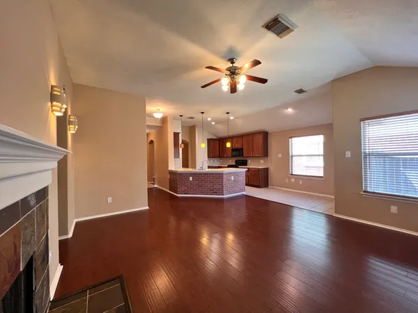 a view of a livingroom with a kitchen and a fireplace
