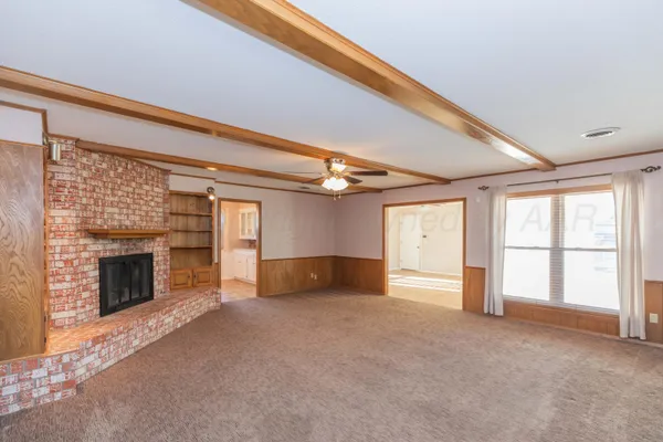 a view of empty room with a fireplace