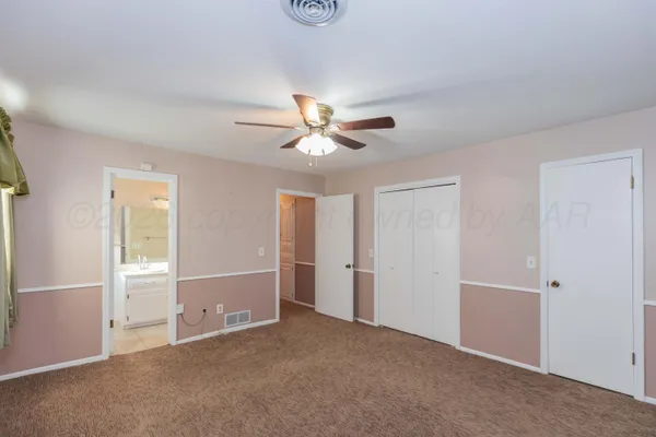 a view of a room with a ceiling fan and a window