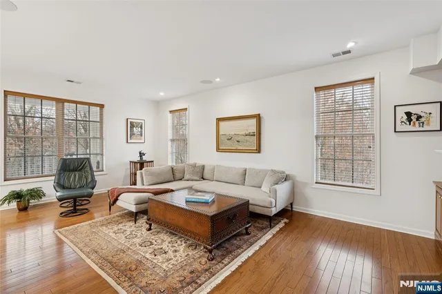 a living room with furniture rug and wooden floor