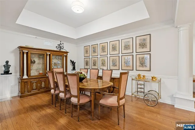 a dining room with furniture and wooden floor
