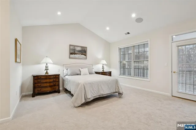 a spacious bedroom with a bed and a window