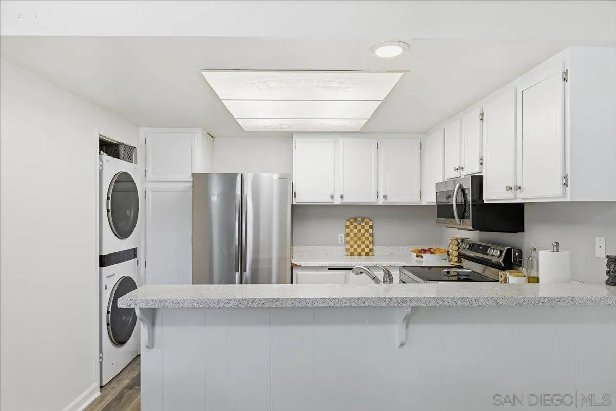 8825 Tamberly Way, Unit A Santee, CA 92071 - Photo 11 of 23 a kitchen with a sink a refrigerator and cabinets