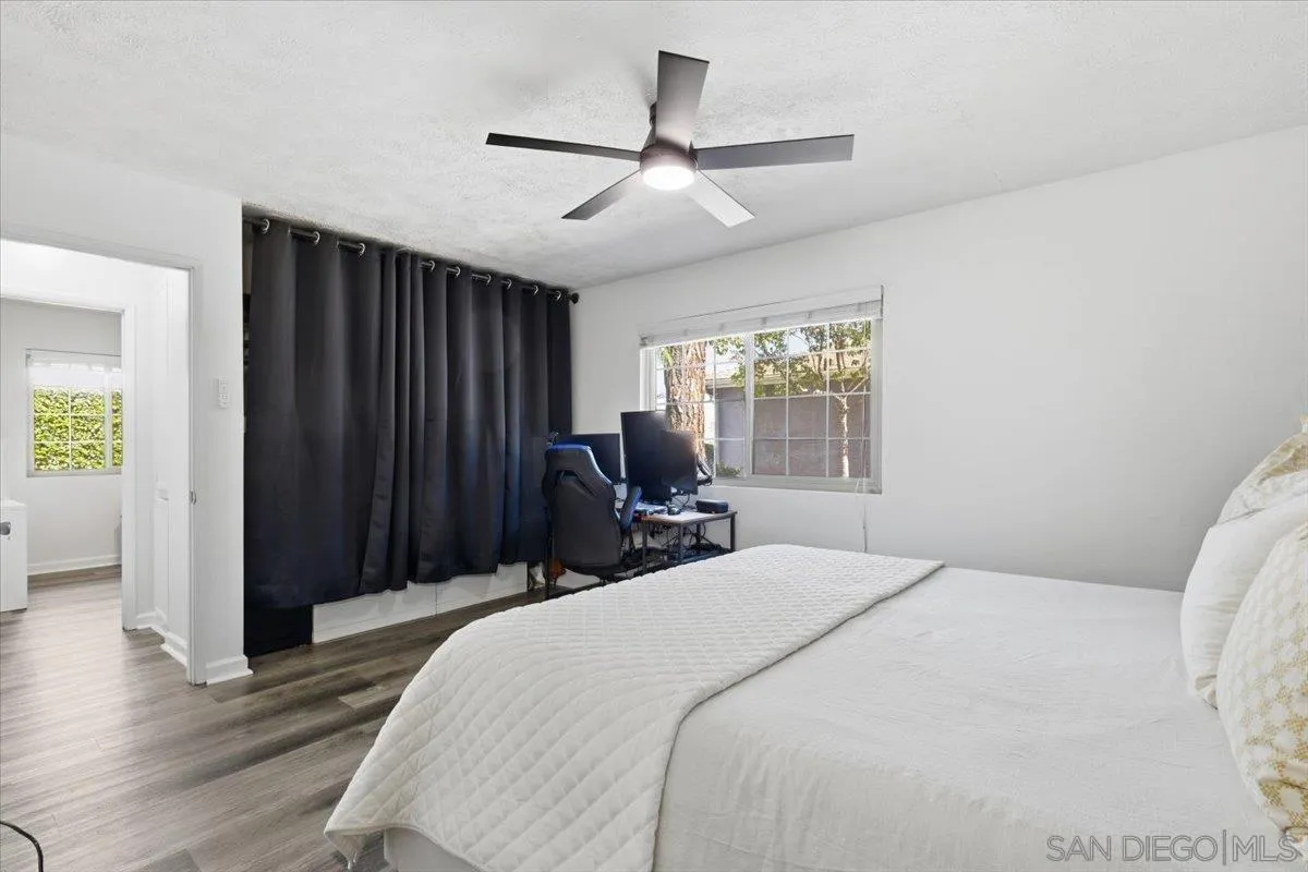 8825 Tamberly Way, Unit A Santee, CA 92071 - Photo 16 of 23 a bedroom with a bed and a large window