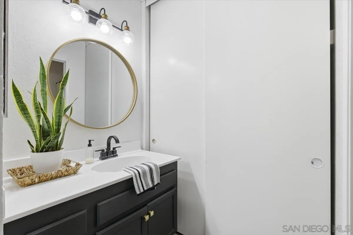 8825 Tamberly Way, Unit A Santee, CA 92071 - Photo 17 of 23 a bathroom with a sink and a mirror