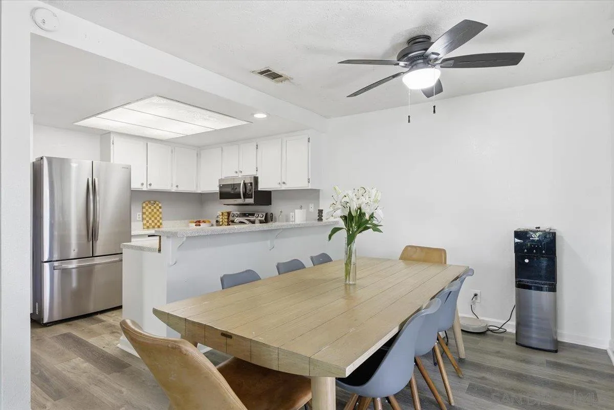 8825 Tamberly Way, Unit A Santee, CA 92071 - Photo 7 of 23 a kitchen with a table chairs and refrigerator