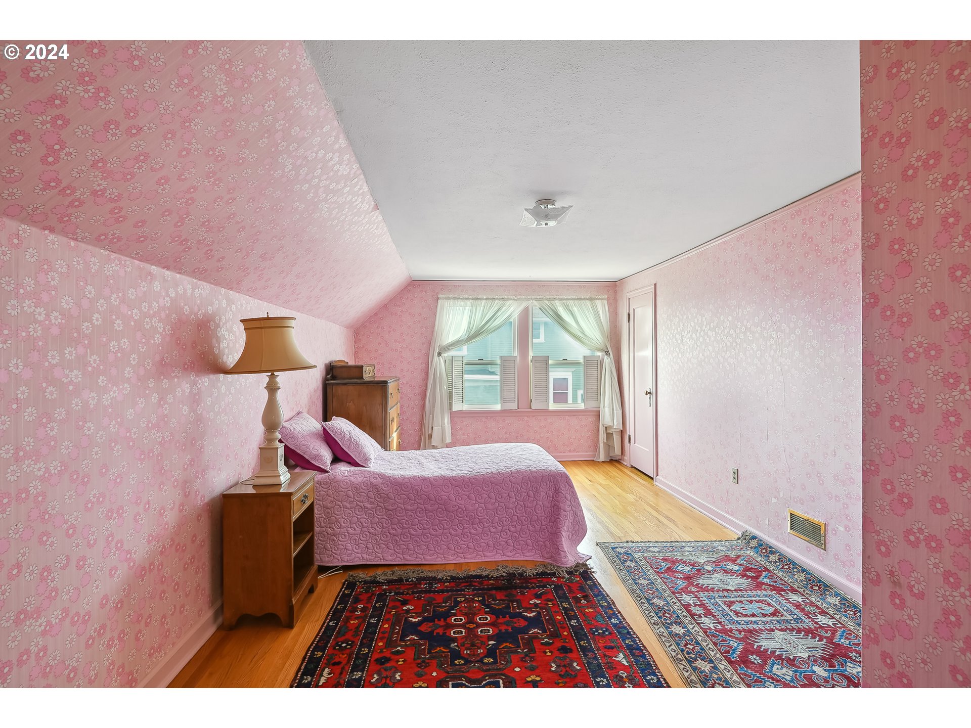 1628 Southwest College Street Portland, OR 97201 - Photo 16 of 25 a bedroom with a bed and wooden floor