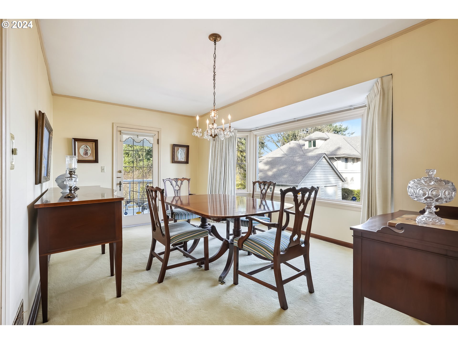 1628 Southwest College Street Portland, OR 97201 - Photo 7 of 25 a view of a dining room and livingroom with furniture wooden floor a rug a painting and a chandelier