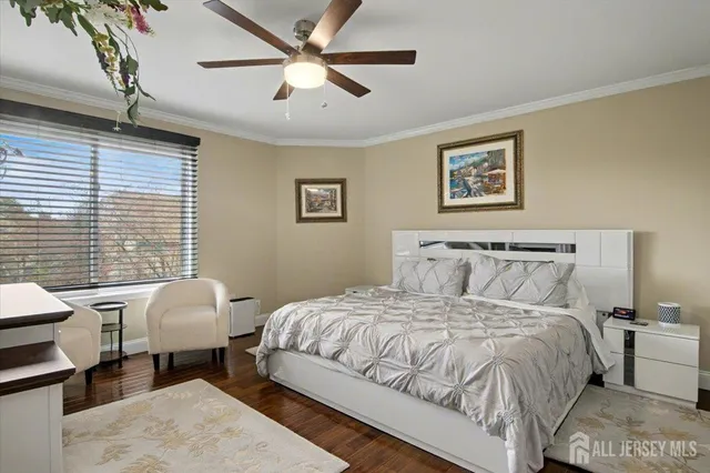 a bedroom with a large bed and a flat screen tv