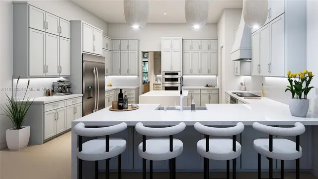 a kitchen with stainless steel appliances kitchen island a table chairs and a refrigerator