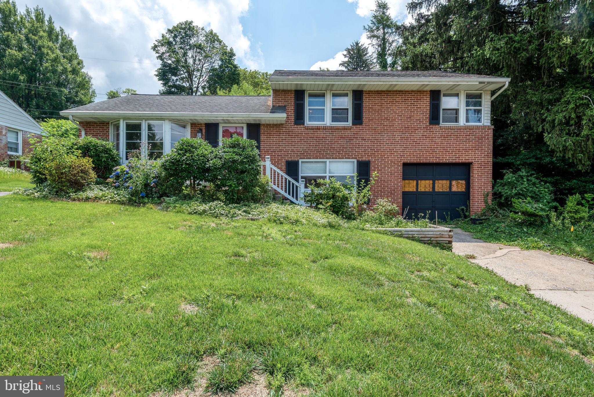 748 Clearmount Road York, PA 17403 - Photo 1 of 28 a front view of a house with a garden and yard