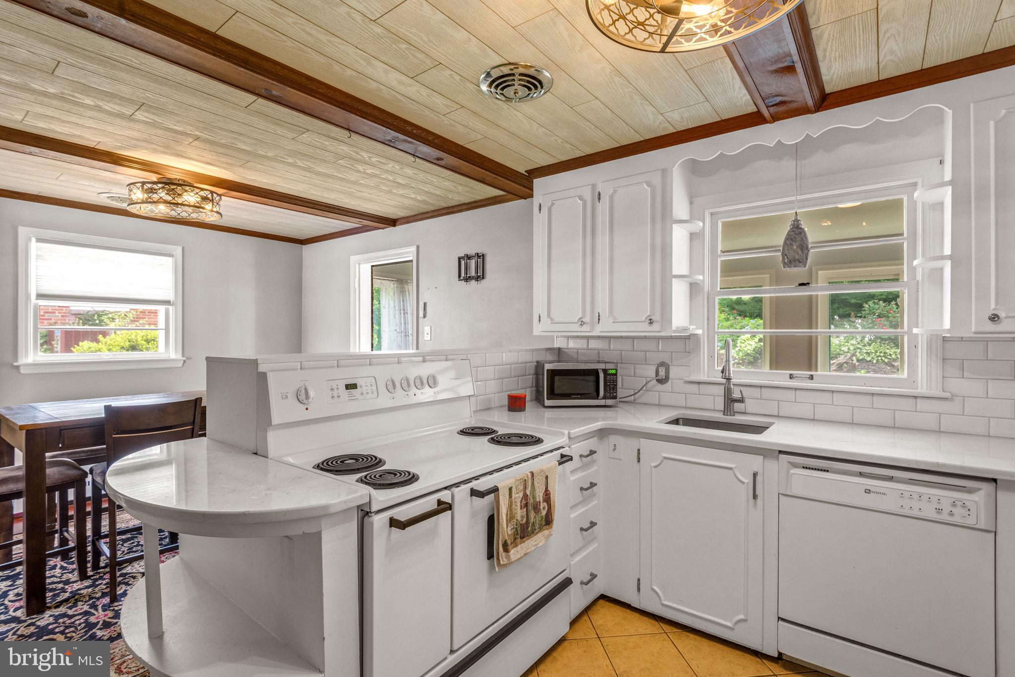 748 Clearmount Road York, PA 17403 - Photo 11 of 28 a kitchen with a stove a sink and a refrigerator