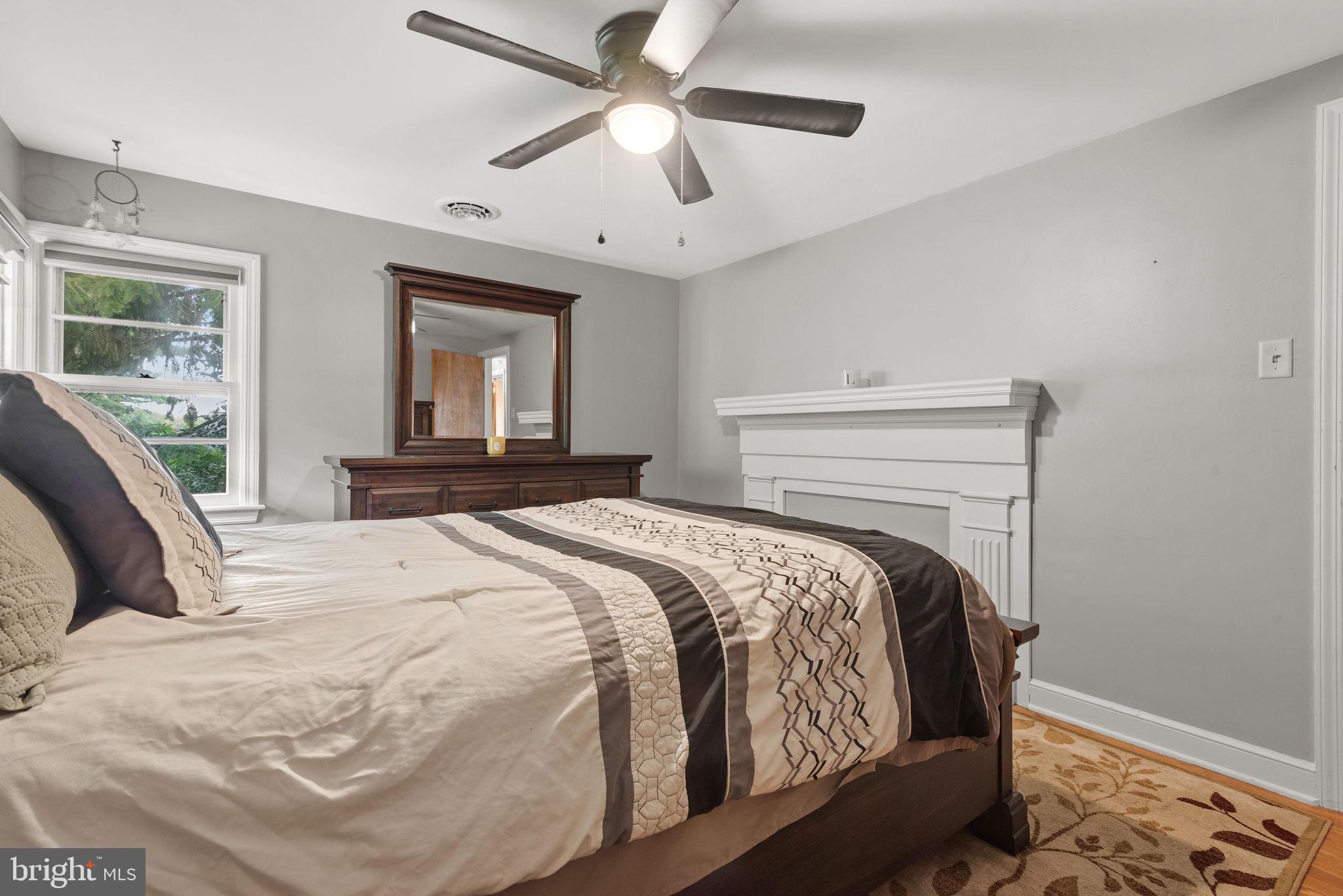 748 Clearmount Road York, PA 17403 - Photo 17 of 28 a bedroom with a large bed and a chandelier fan