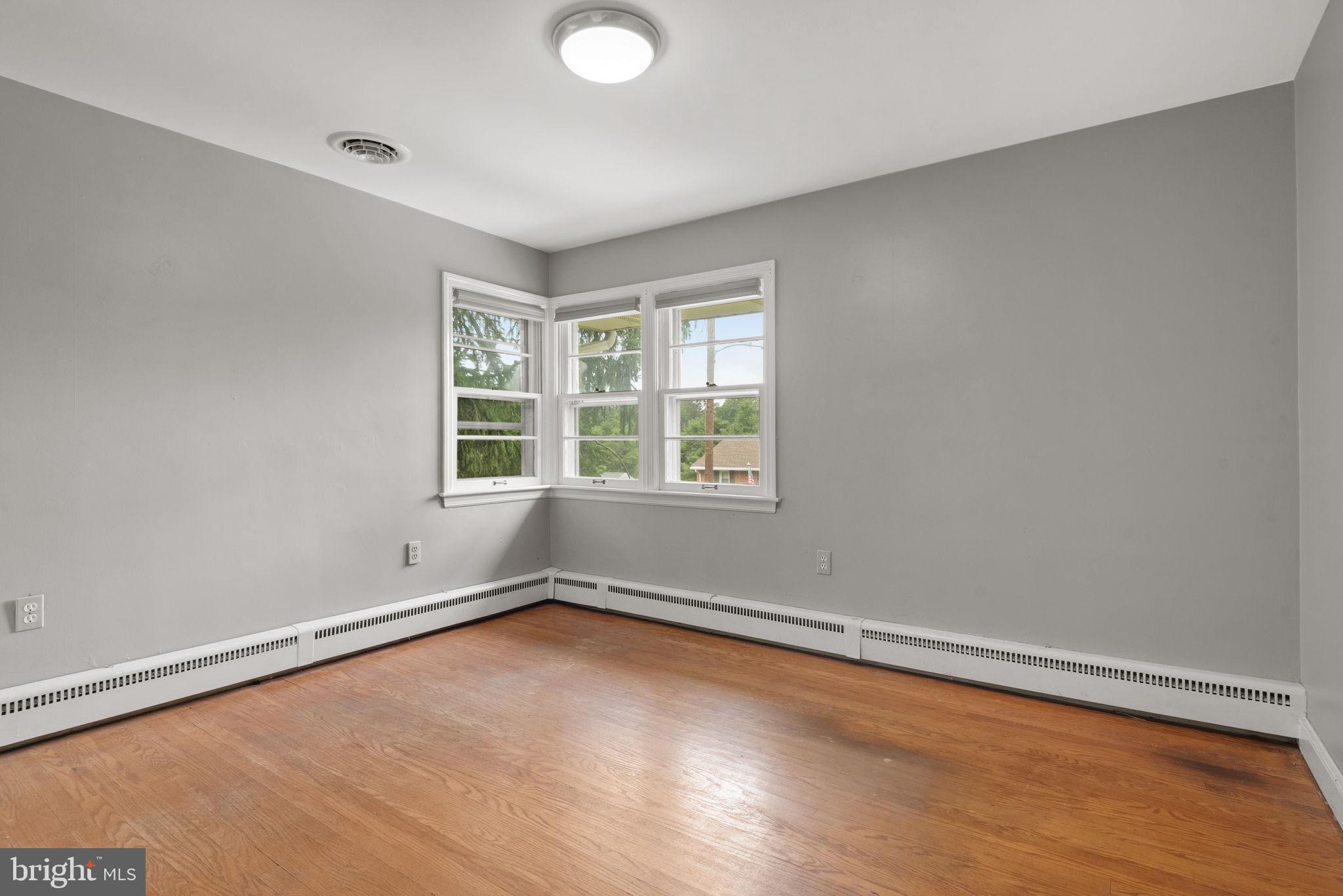 748 Clearmount Road York, PA 17403 - Photo 19 of 28 an empty room with wooden floor and windows