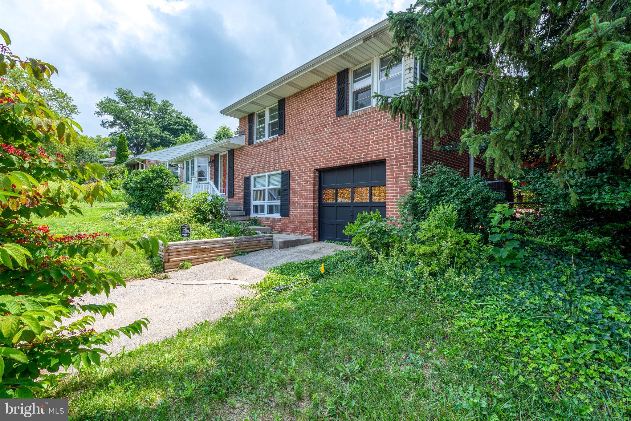 748 Clearmount Road York, PA 17403 - Photo 2 of 28 a front view of a house with a garden