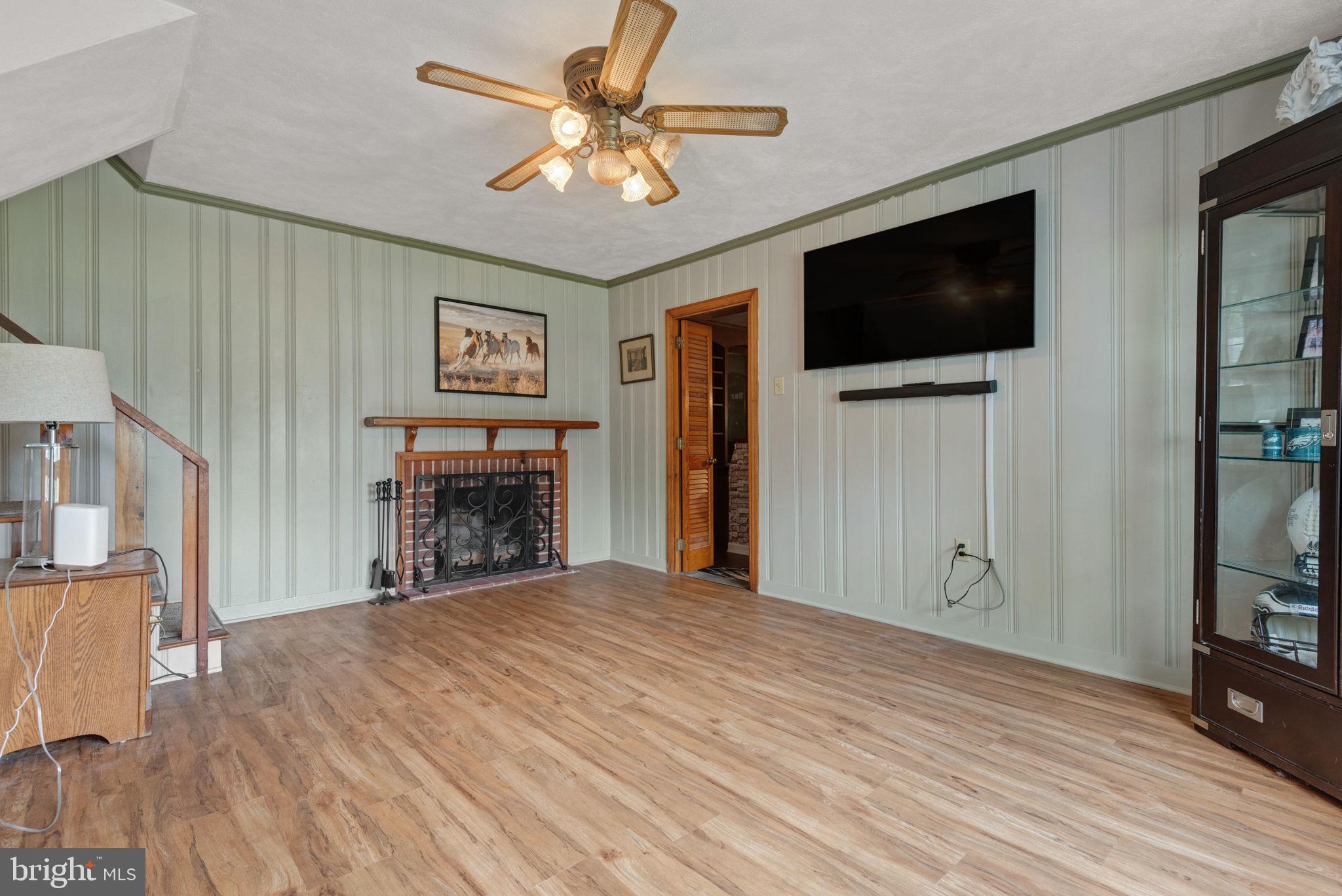 748 Clearmount Road York, PA 17403 - Photo 25 of 28 a view of livingroom with flat screen tv ceiling fan and a fireplace