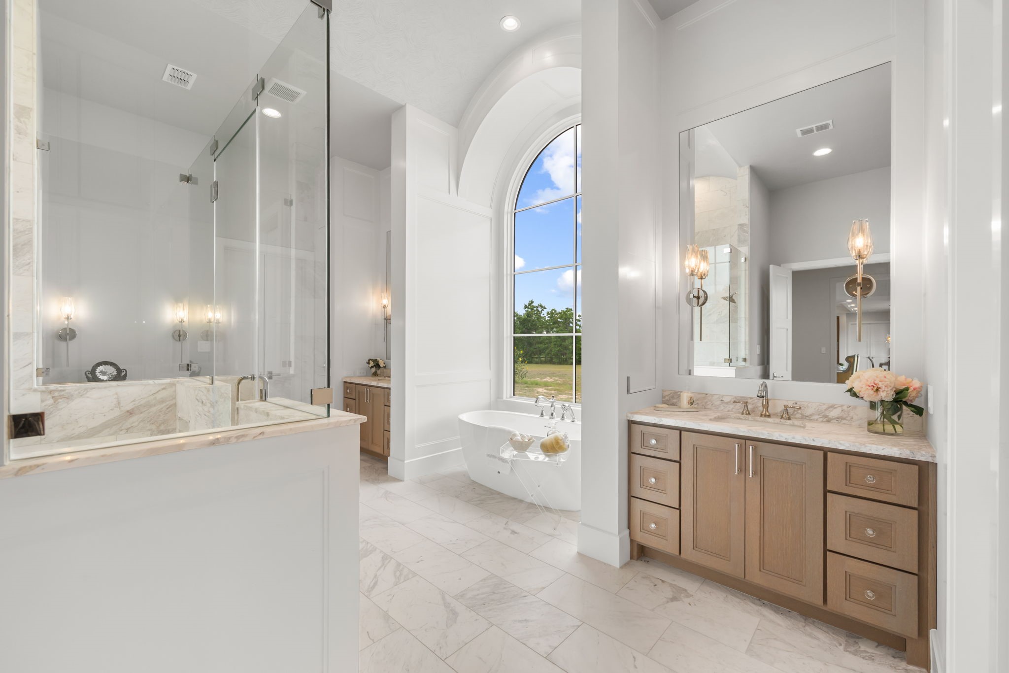 4233 Two Gun Way Katy, TX 77494 - Photo 20 of 47 Stunning primary bath with large walk-in shower, soaking tub, two vanities with sinks and a third sit down vanity all with sconce lighting in addition to overhead lighting.