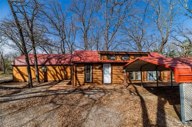 a backyard of a house with barbeque oven