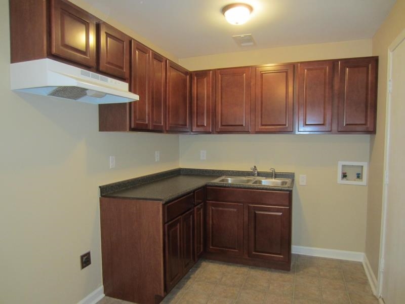 294 Elder Road Memphis, TN 38109 - Photo 3 of 8 a kitchen with a sink and cabinets