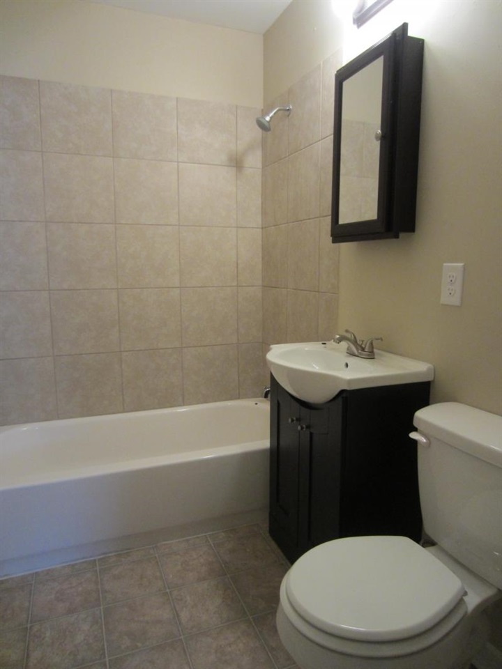 294 Elder Road Memphis, TN 38109 - Photo 4 of 8 a white toilet sitting next to a bathroom sink
