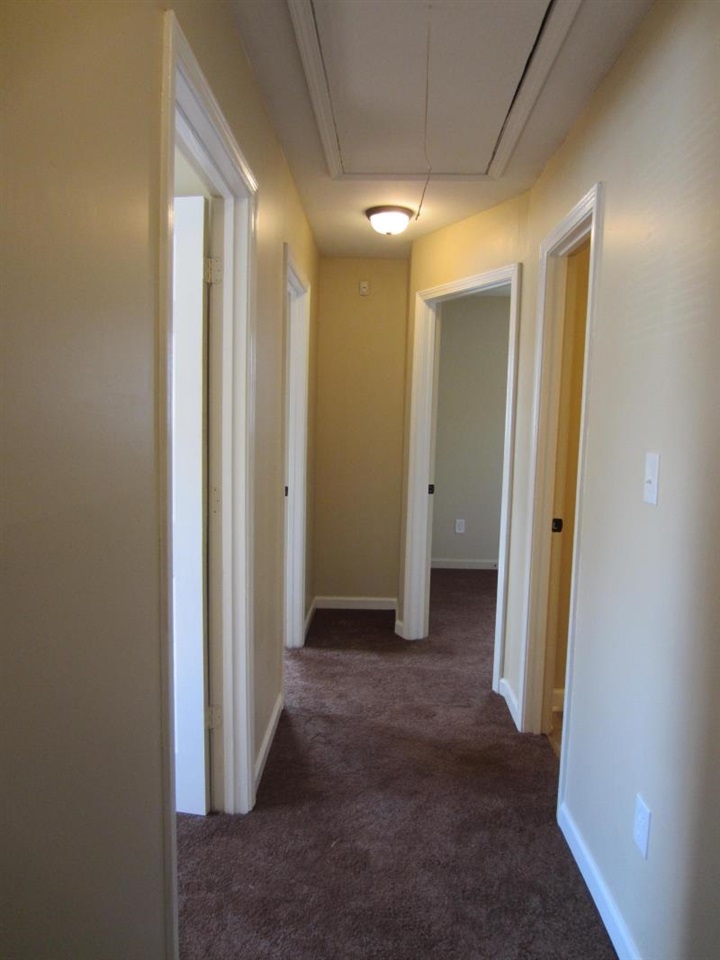 294 Elder Road Memphis, TN 38109 - Photo 5 of 8 a view of a hallway with closet and wooden floor