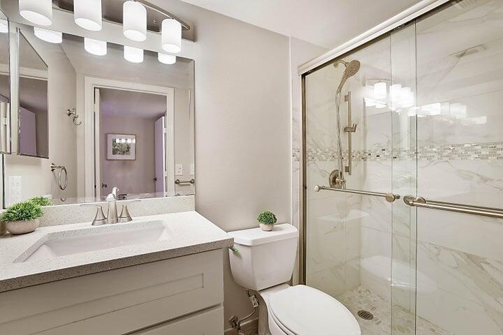 306 Pine Ridge Circle, Unit D1 Greenacres, FL 33463 - Photo 17 of 26 a bathroom with a sink toilet and shower