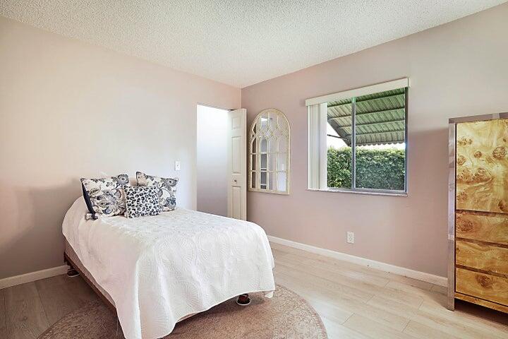 306 Pine Ridge Circle, Unit D1 Greenacres, FL 33463 - Photo 19 of 26 a bedroom with a bed and a window