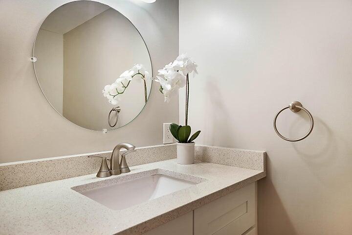 306 Pine Ridge Circle, Unit D1 Greenacres, FL 33463 - Photo 20 of 26 a bathroom with a sink and a mirror