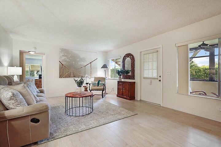 306 Pine Ridge Circle, Unit D1 Greenacres, FL 33463 - Photo 23 of 26 a living room with furniture a rug and a large window