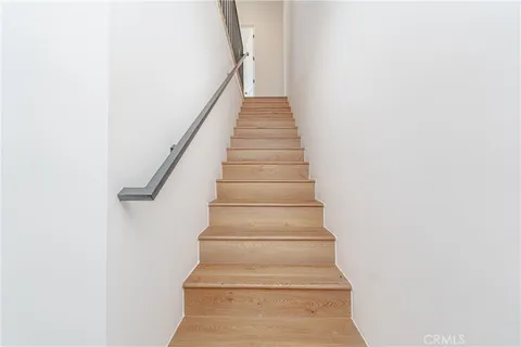 a kitchen with refrigerator cabinets and wooden floor