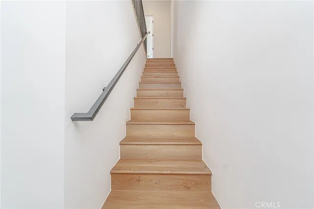 a kitchen with refrigerator cabinets and wooden floor