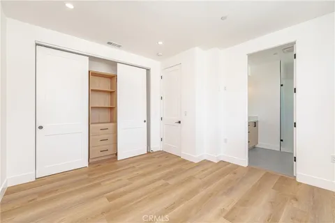 a view of a room with wooden floor and white doors